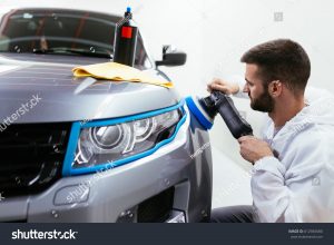stock-photo-car-detailing-hands-with-orbital-polisher-in-auto-repair-shop-front-lights-protected-with-612945680