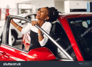 stock-photo-woman-buying-the-car-lady-in-a-car-salon-elegant-black-girl-1399930568